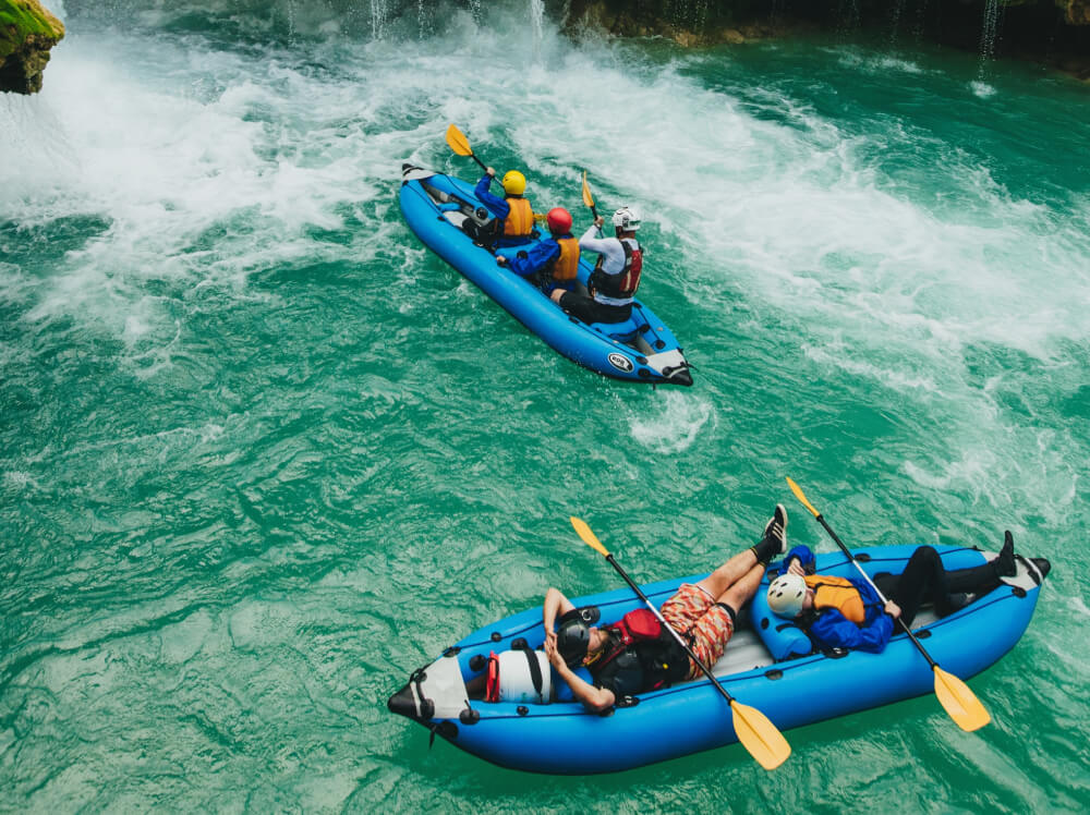 People on a corporate retreat enjoying their rafting experience.