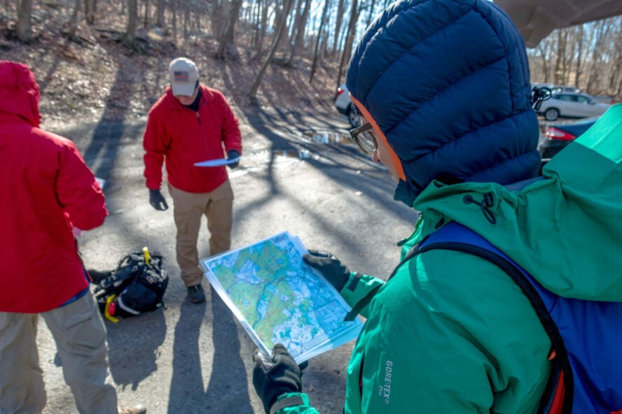 Karmen –bless her cold legs– studies the terrain while we gear up.