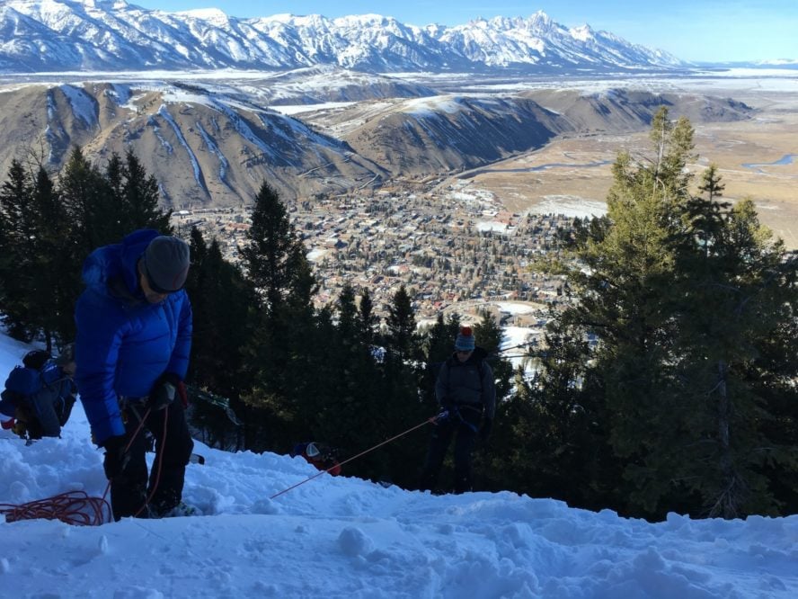 A group of ski mountaineers learning how to build anchors during a ski mountaineering day in the Tetons.