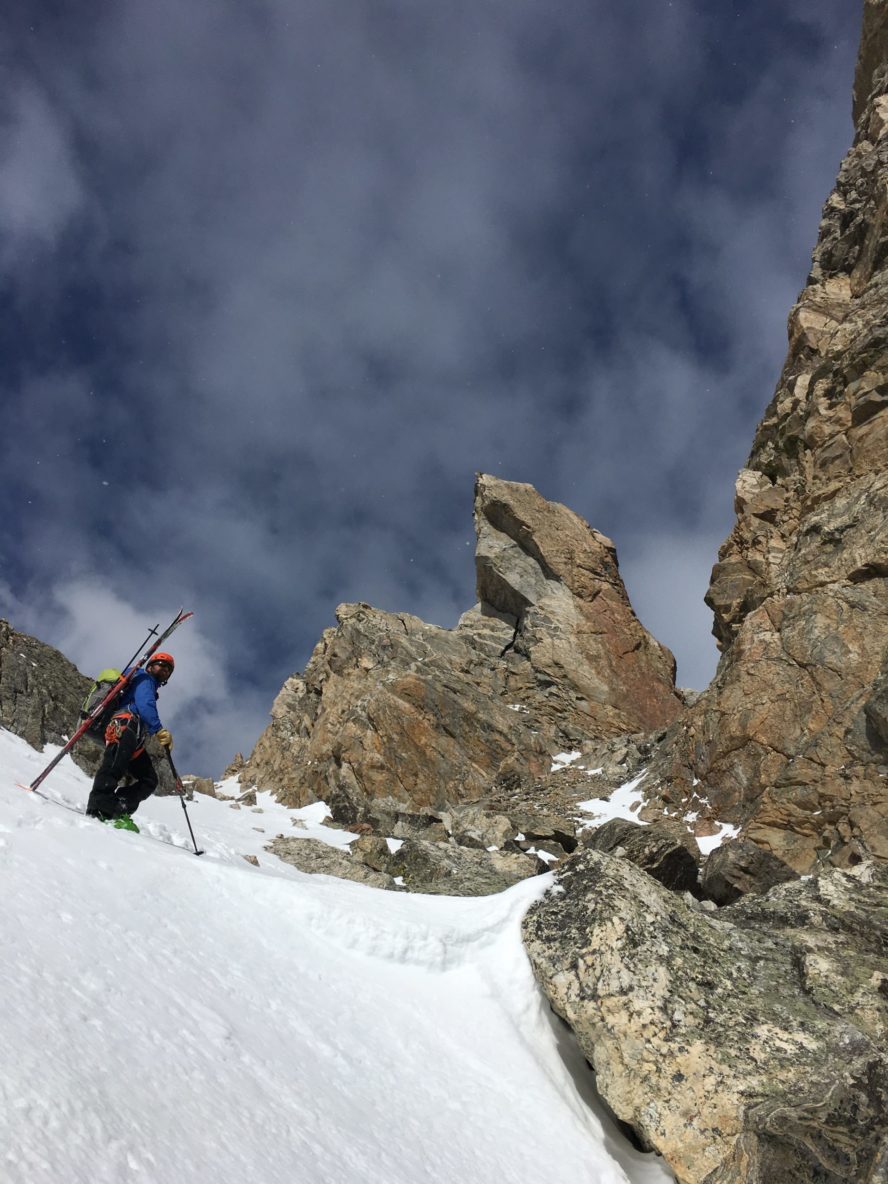 A ski mountaineer on top of a high-altitude ski line in the Tetons.