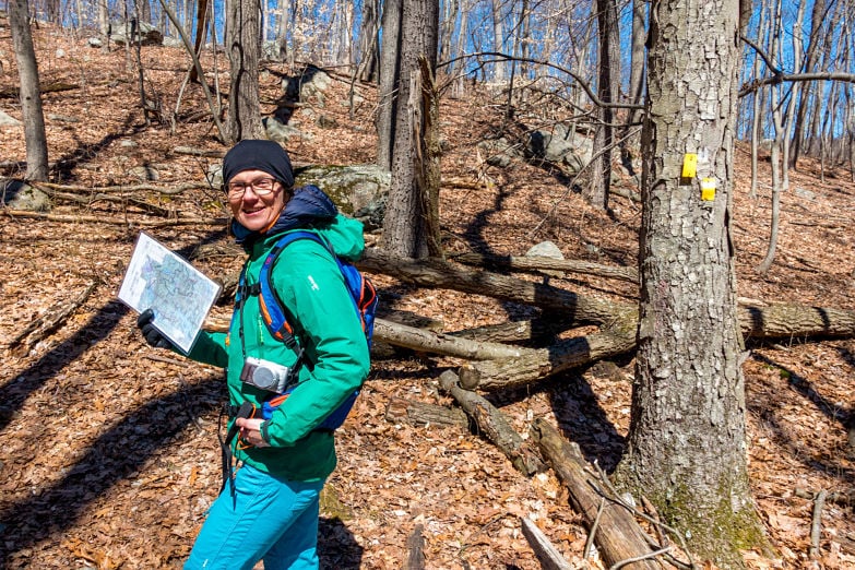 Karmen leads on the “Yellow” trail. The blazes say turn left.