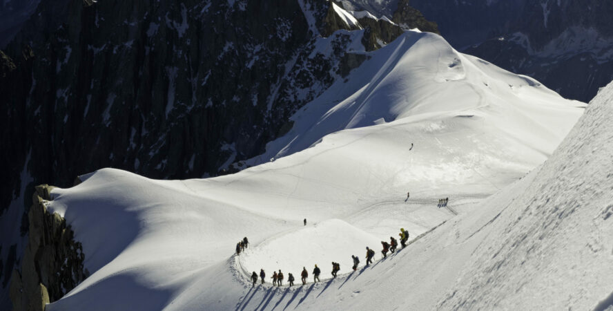 Skiers making their way down the ridge into La Valle Blanche