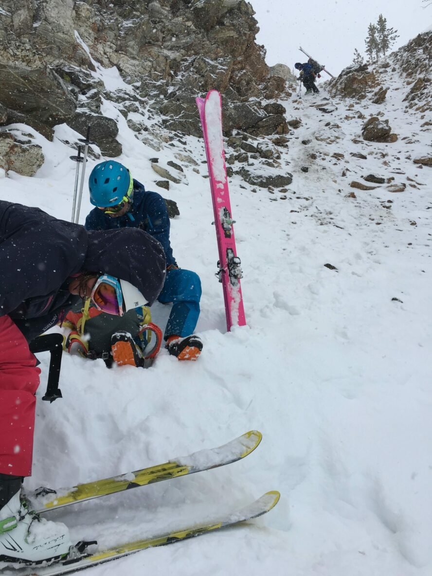 Skier's beginning to rappel