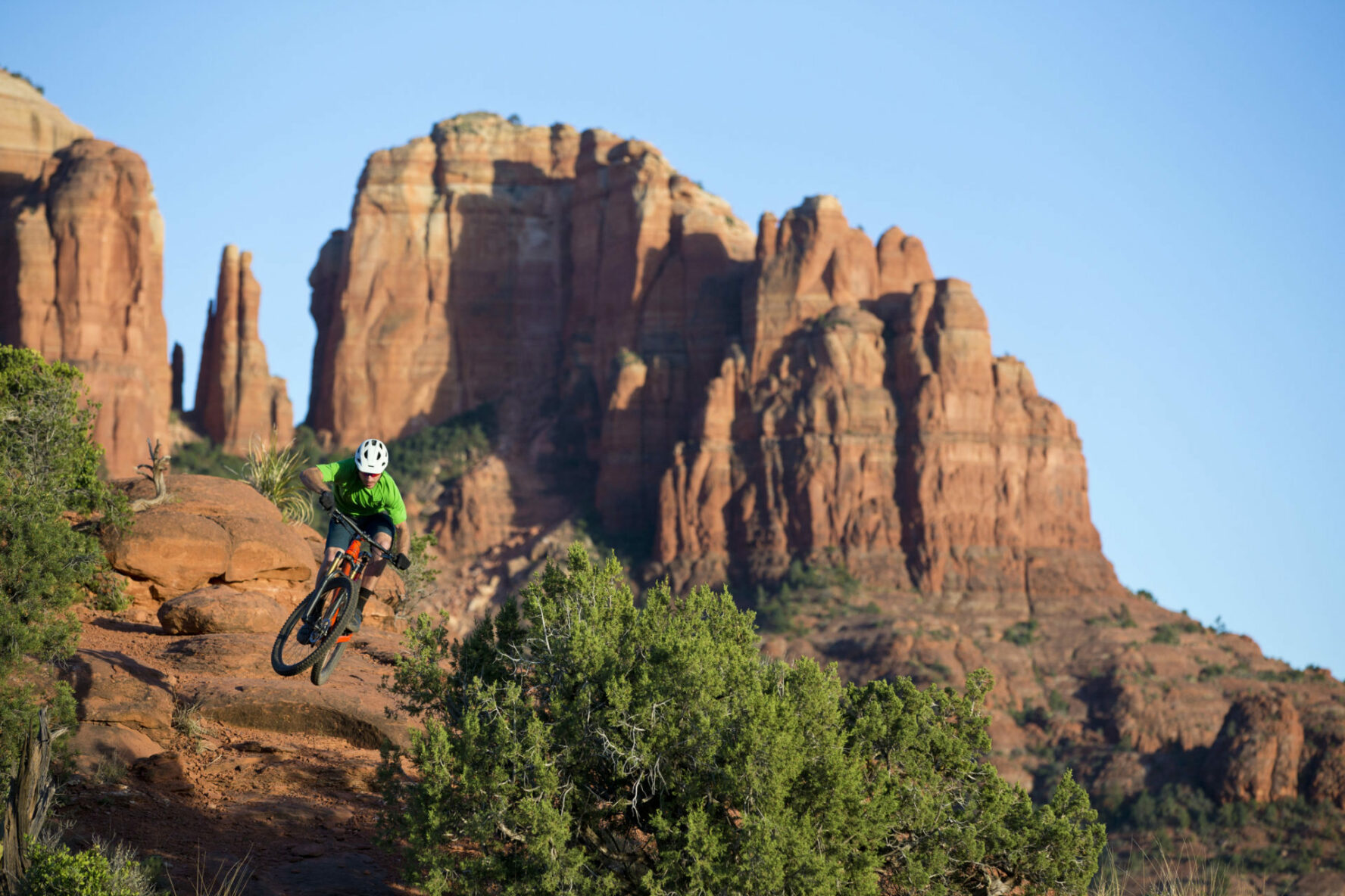 man jumping on mountain bike in sedona