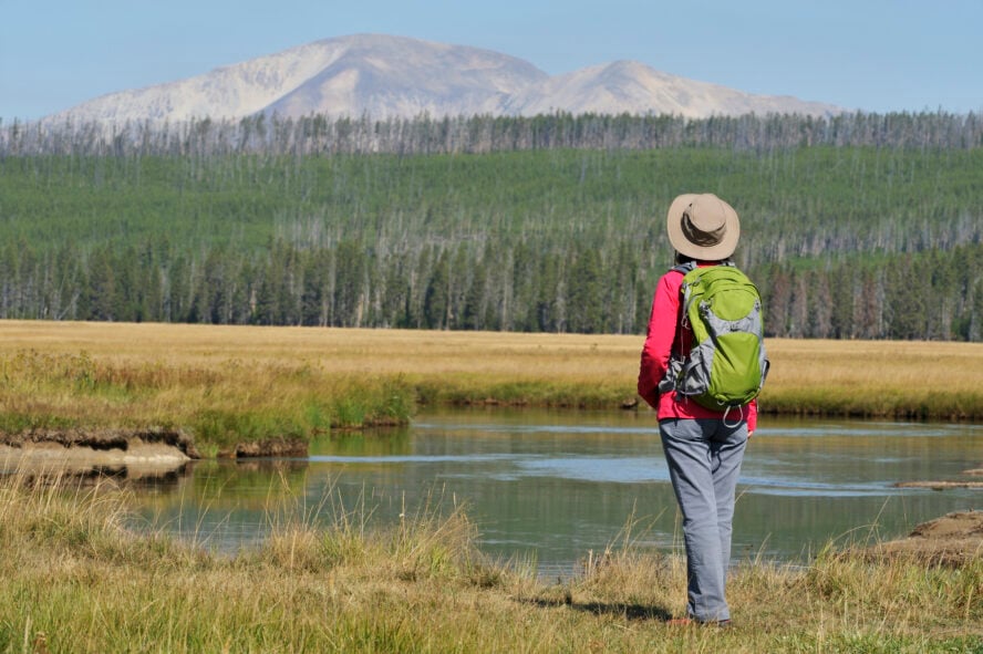 A hiker gazes out over Yellowstone National Park