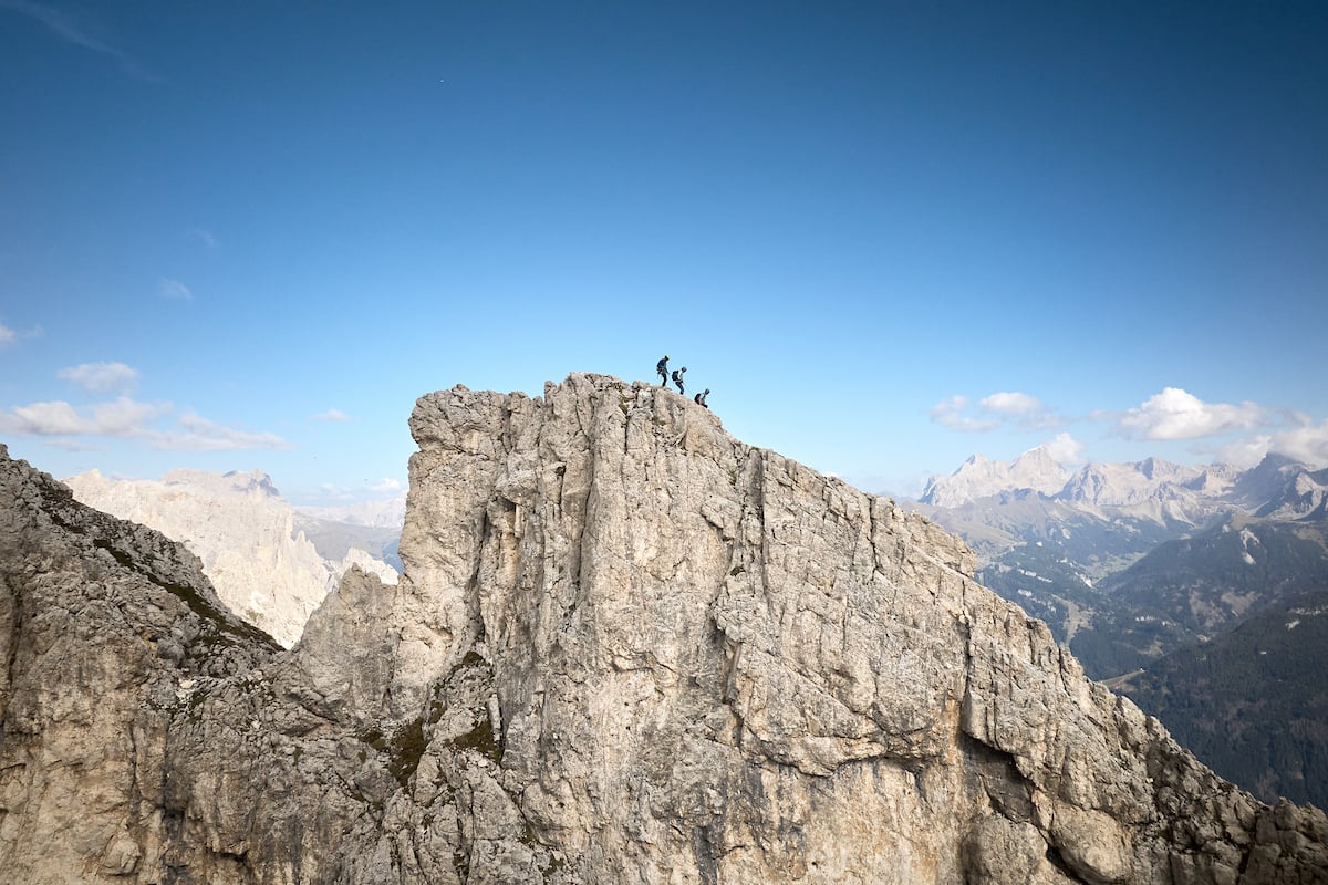 Three climbers and dramatic views in the Dolomites