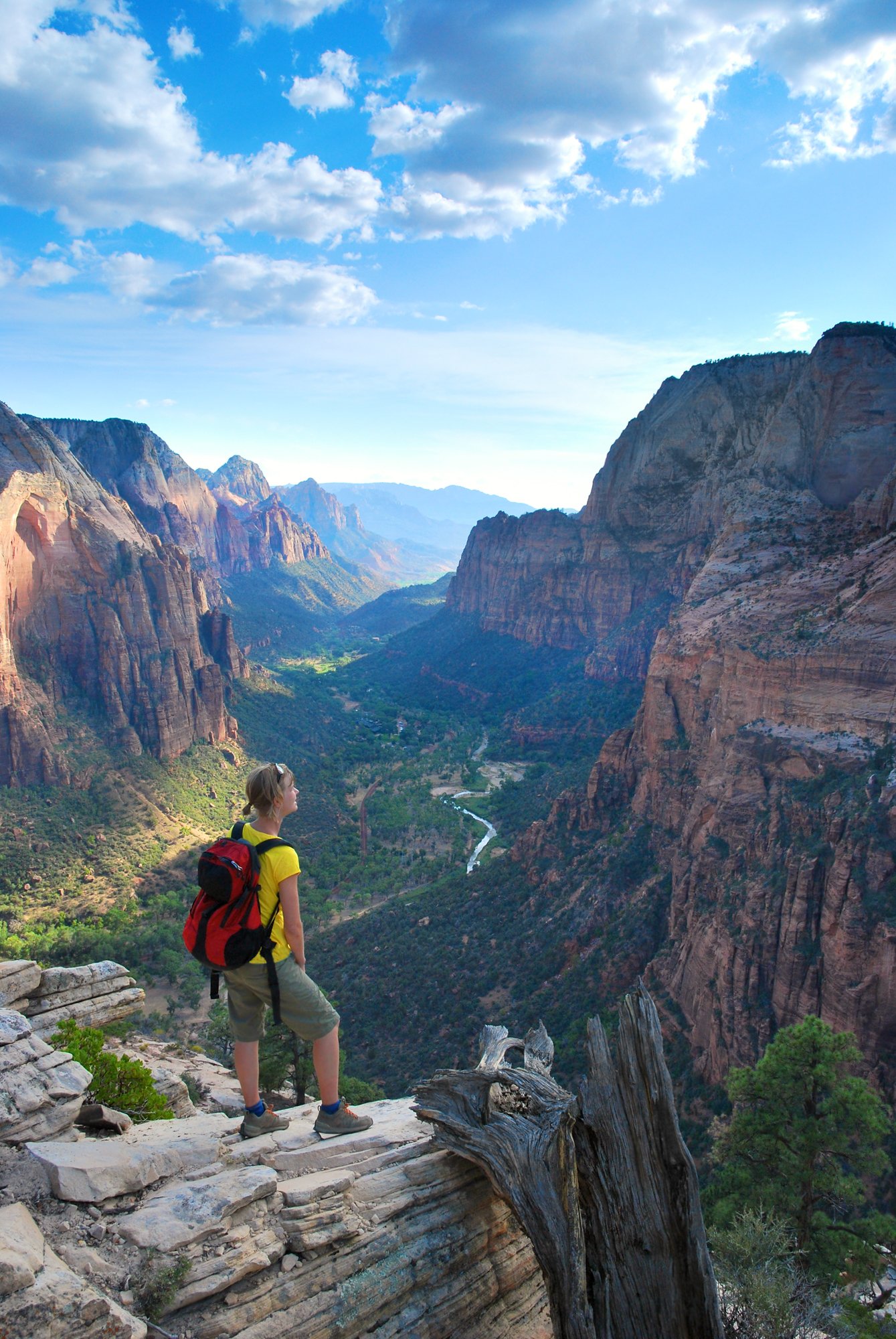 Hipster man with backpack exploring nature in spring, walking