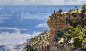 A hiker admiring the viewpoint on the Cape Royal Trail.