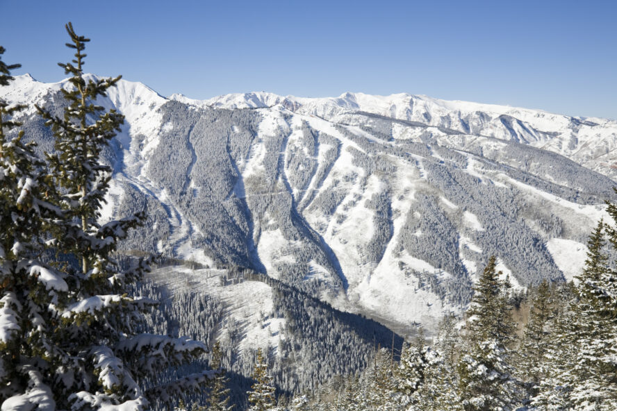 A view of Aspen Highlands from Aspen Mountain. The black diamond runs off the ridge in the background are capped by Highland Bowl on the left.