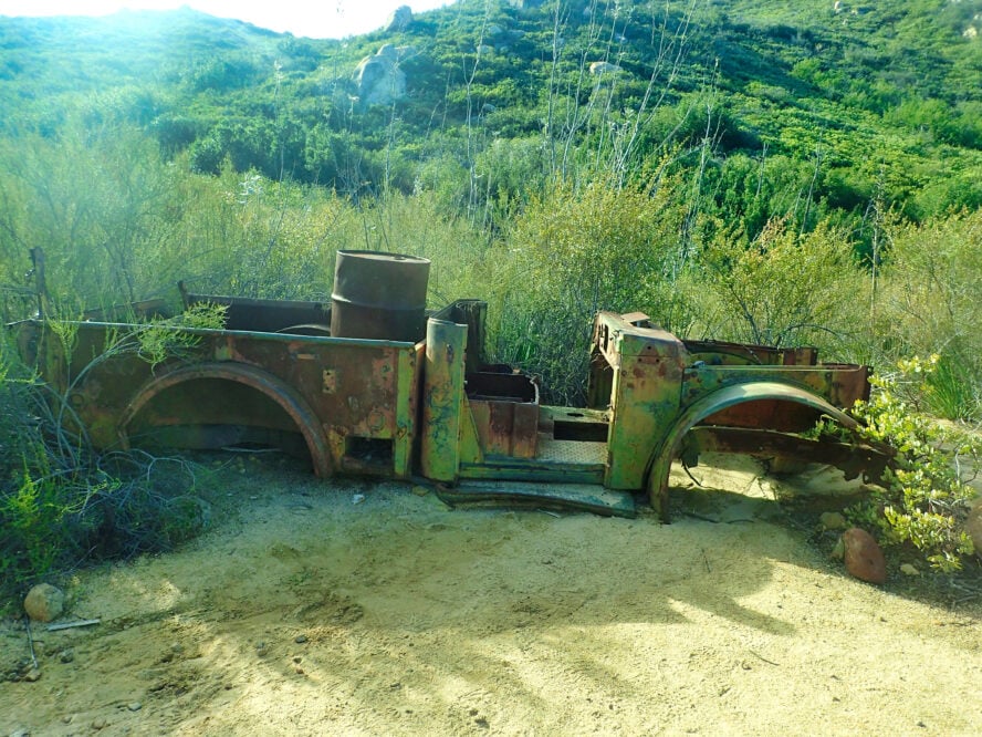 An old rusted out vehicle is one of the many old-timey artifacts scattered around El Cajon