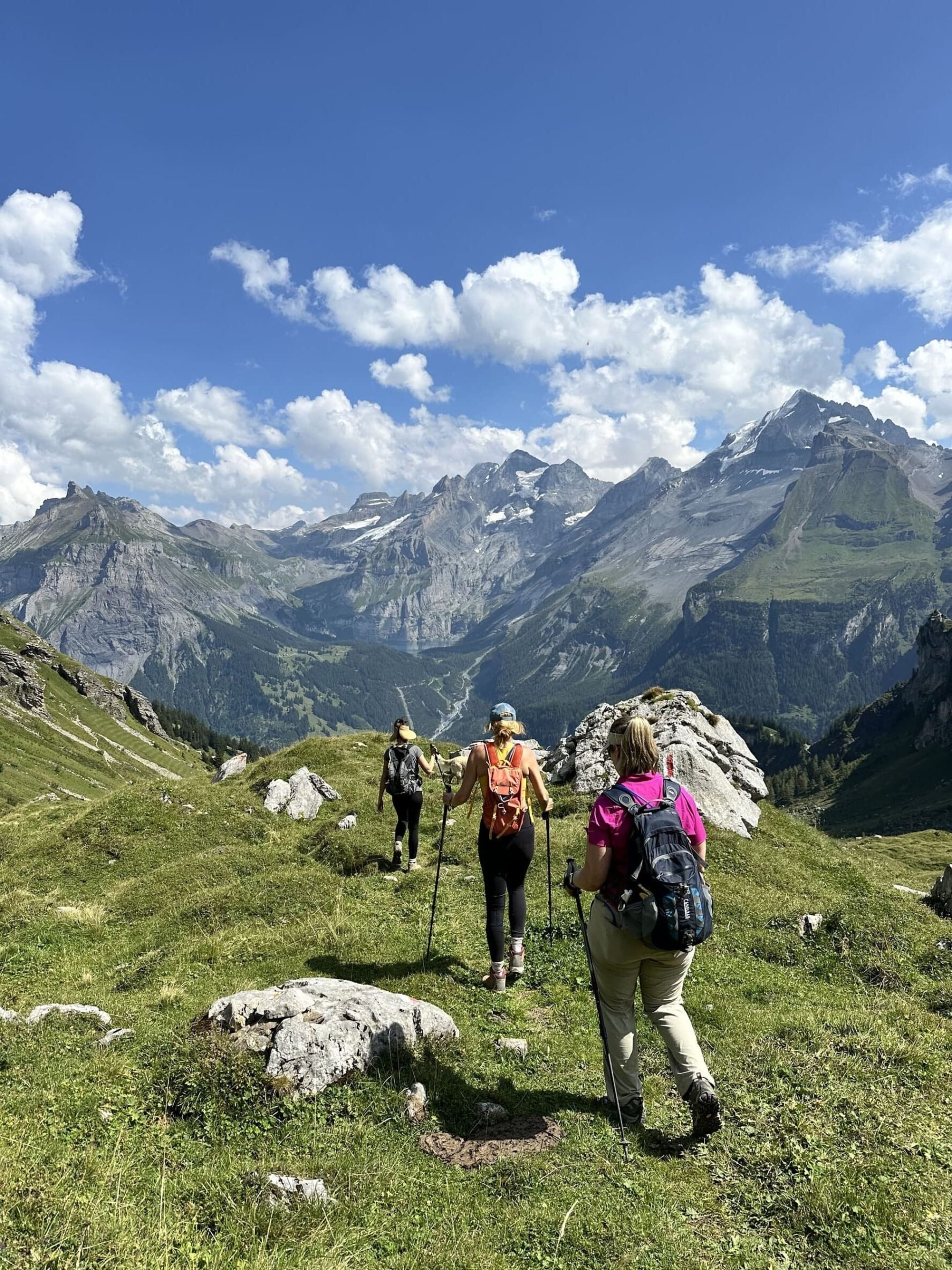 Three hikers on a sunny day in the Swiss Alps