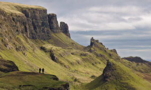 Hikers on the famous Quiraing hiking trail on a cloudy overcast day.