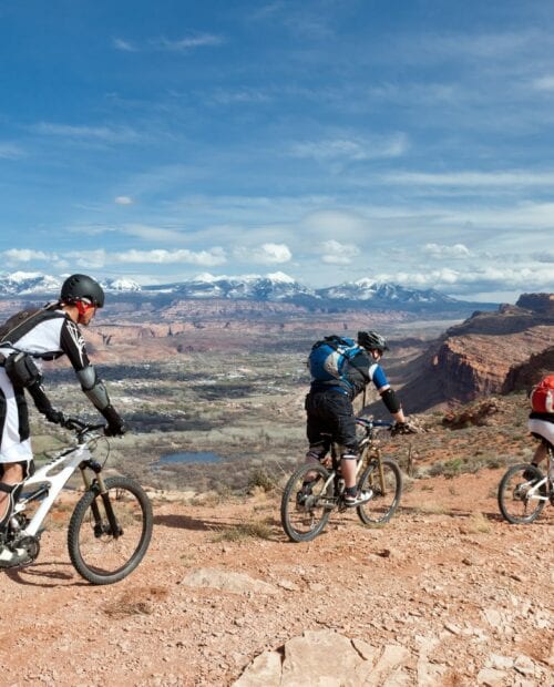 3 people riding a mountain bike in Moab, Utah