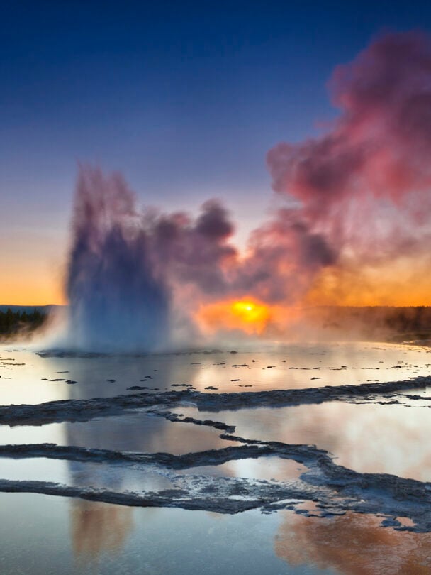 "Woman looking at Lower Falls at Yellowstone National Park, Wyoming, USA."