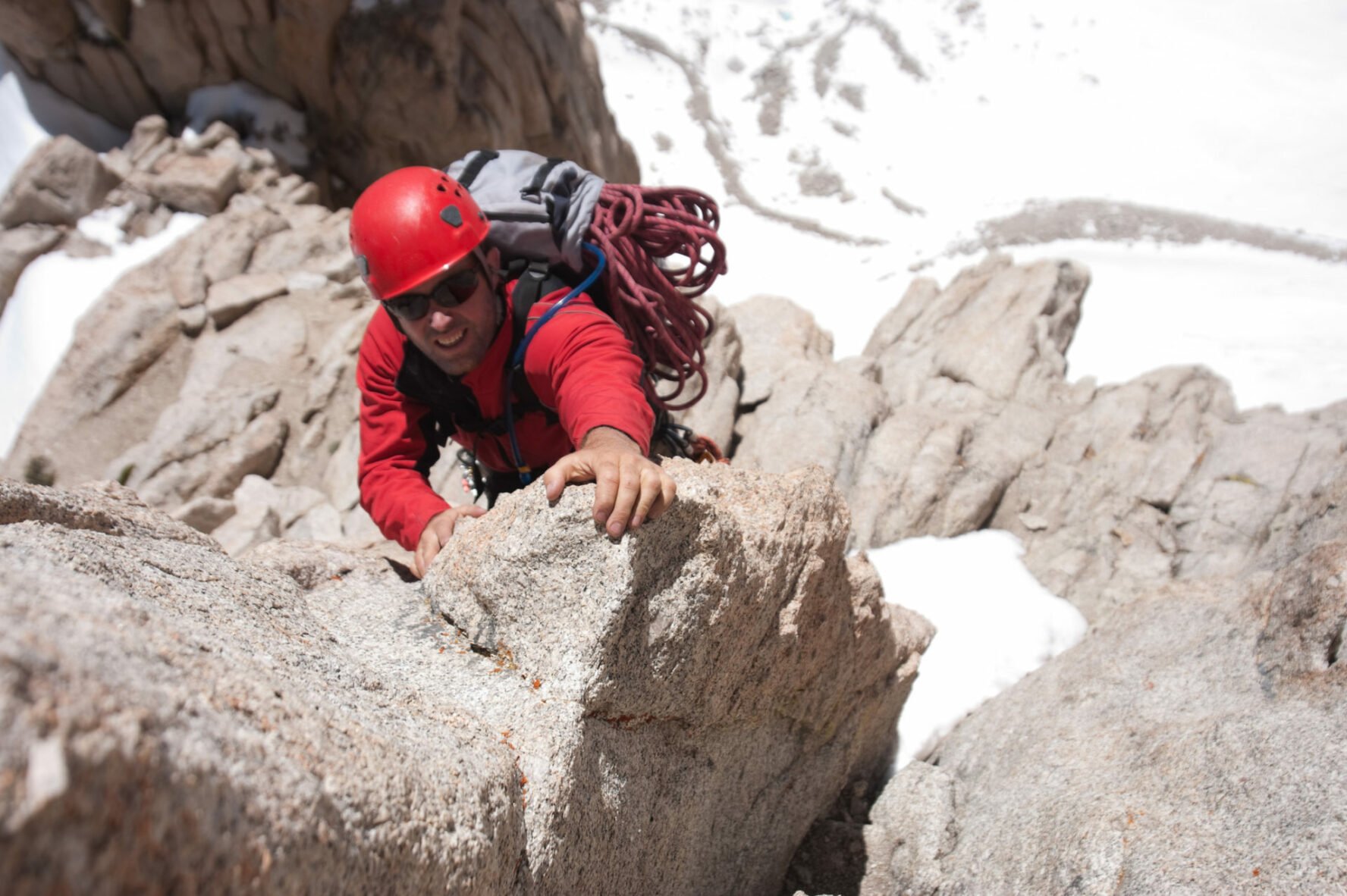 An alpine rock climber on a demanding climbing route in High Sierra.