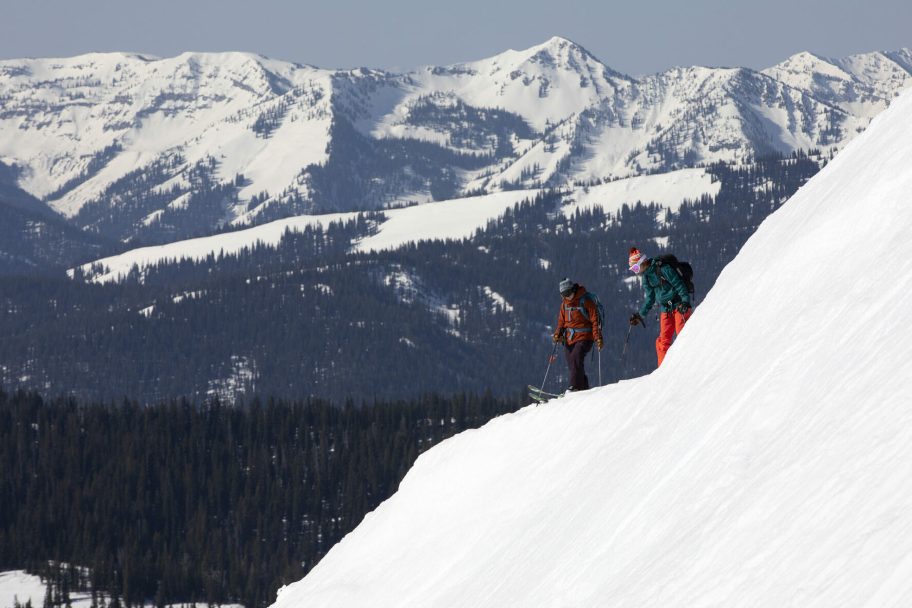 Skiers on a slope overlooking a valley in Grand Teton National Park