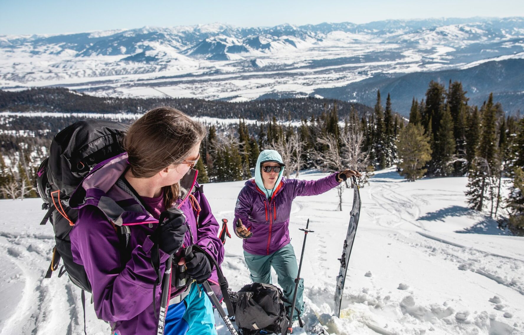 Skiers talking in an epic backdrop in Grand Teton National Park
