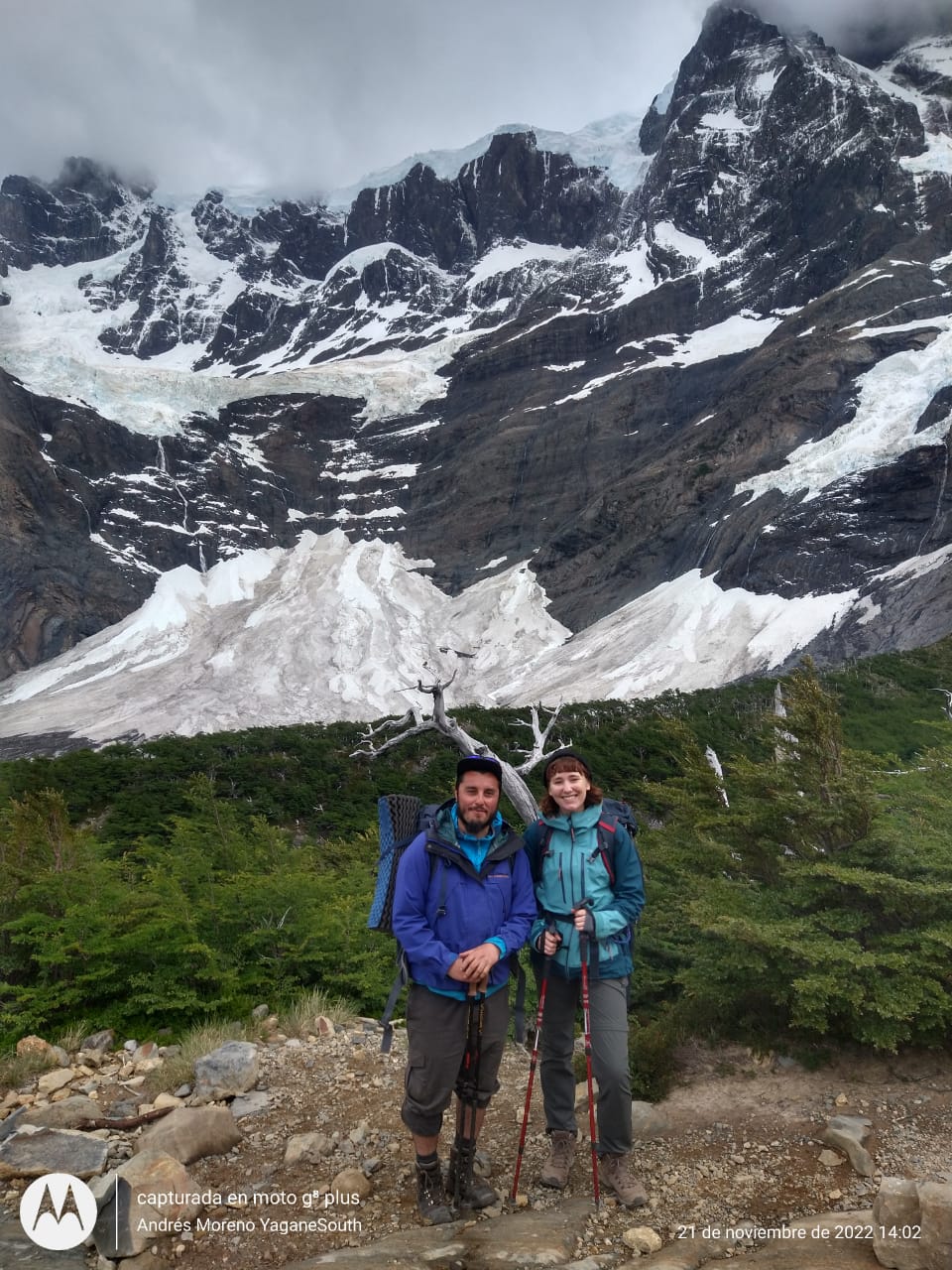 Hikers in front of a mountain with occasional ice