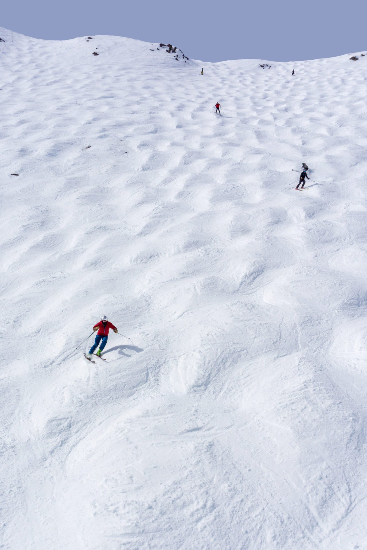 Skiers descending a bumpy slope in Lake Louise