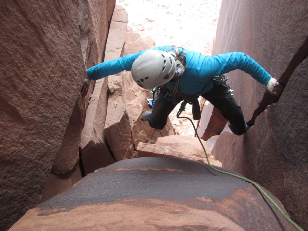 A woman between a tower in Moab