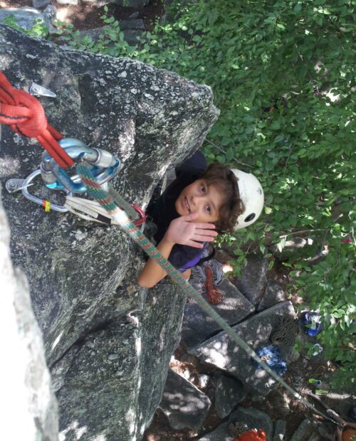 A young climber finishing a route in the Gunks