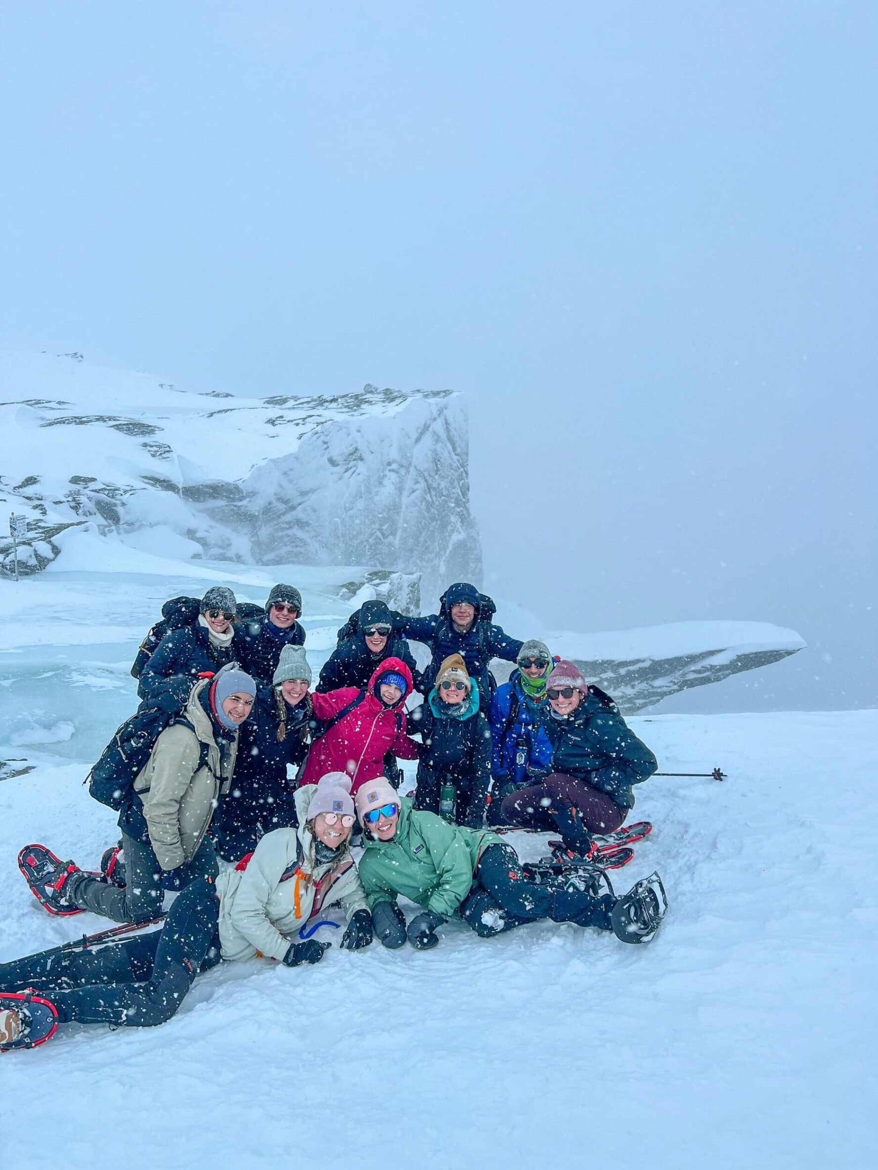 Hiking group smiling on a snowy day on the Trolltunga winter hike