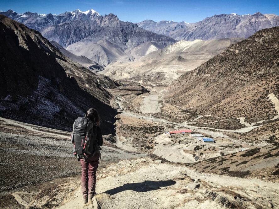 Hiker descending from the Thorung La Pass in Nepal.