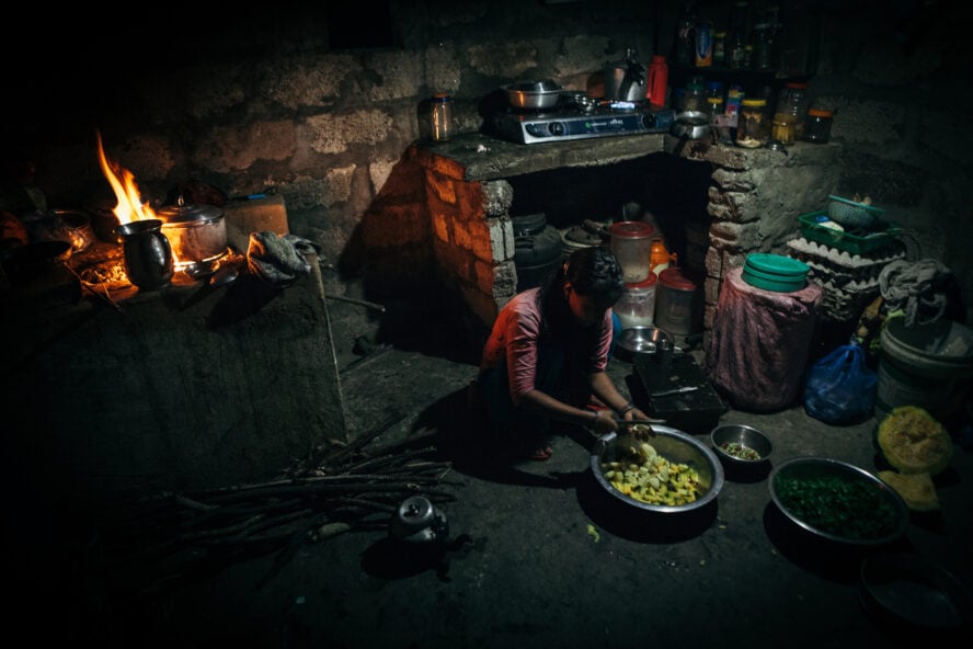 Woman preparing a meal in a Nepali teahouse.