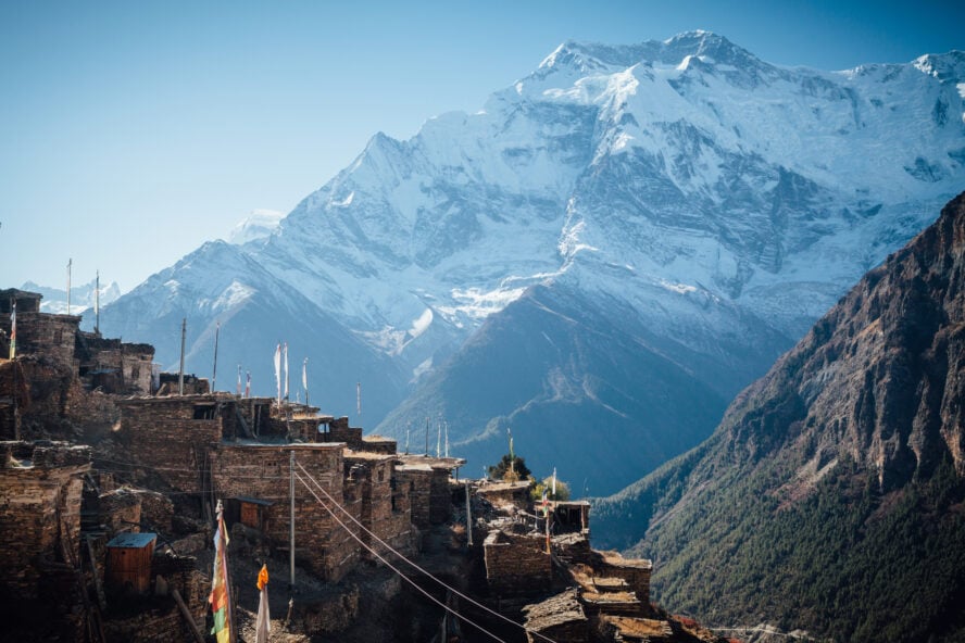 The small terraced village of Ghyaru in Nepal, with the Annapurna II rising in the distance.