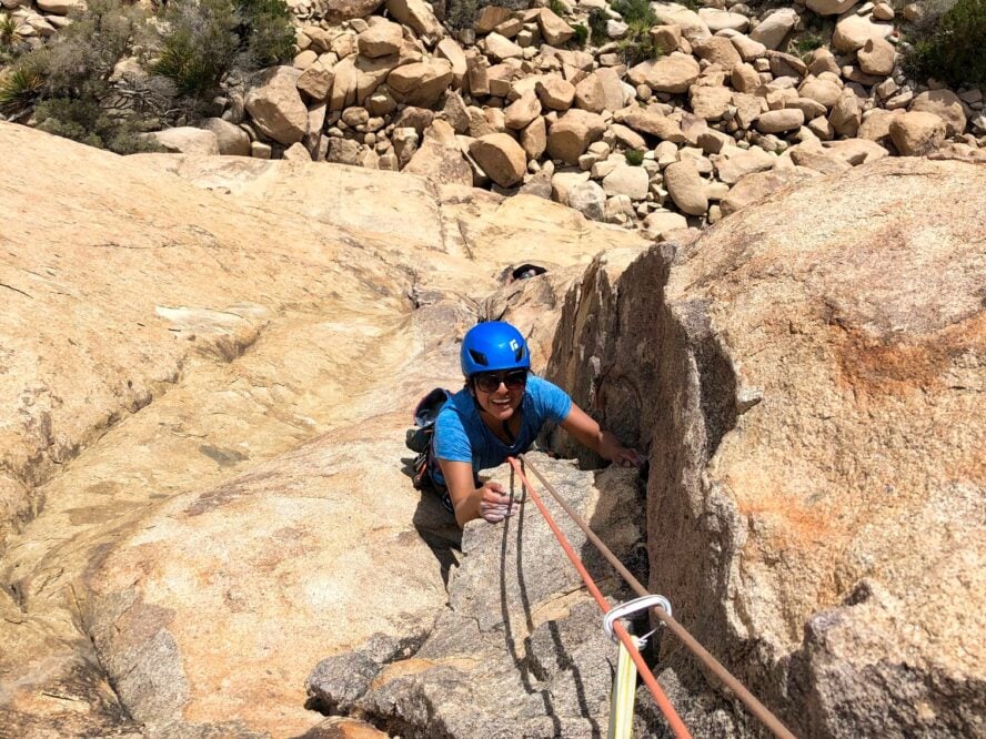 Climber following on toprope, getting comfortable on the grippy monzogranite.