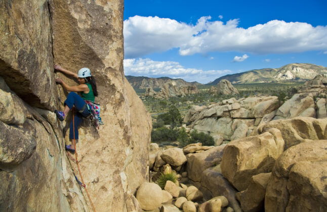 Lead climbing in Joshua Tree, in the high desert terrain, is ideal for all skill levels.