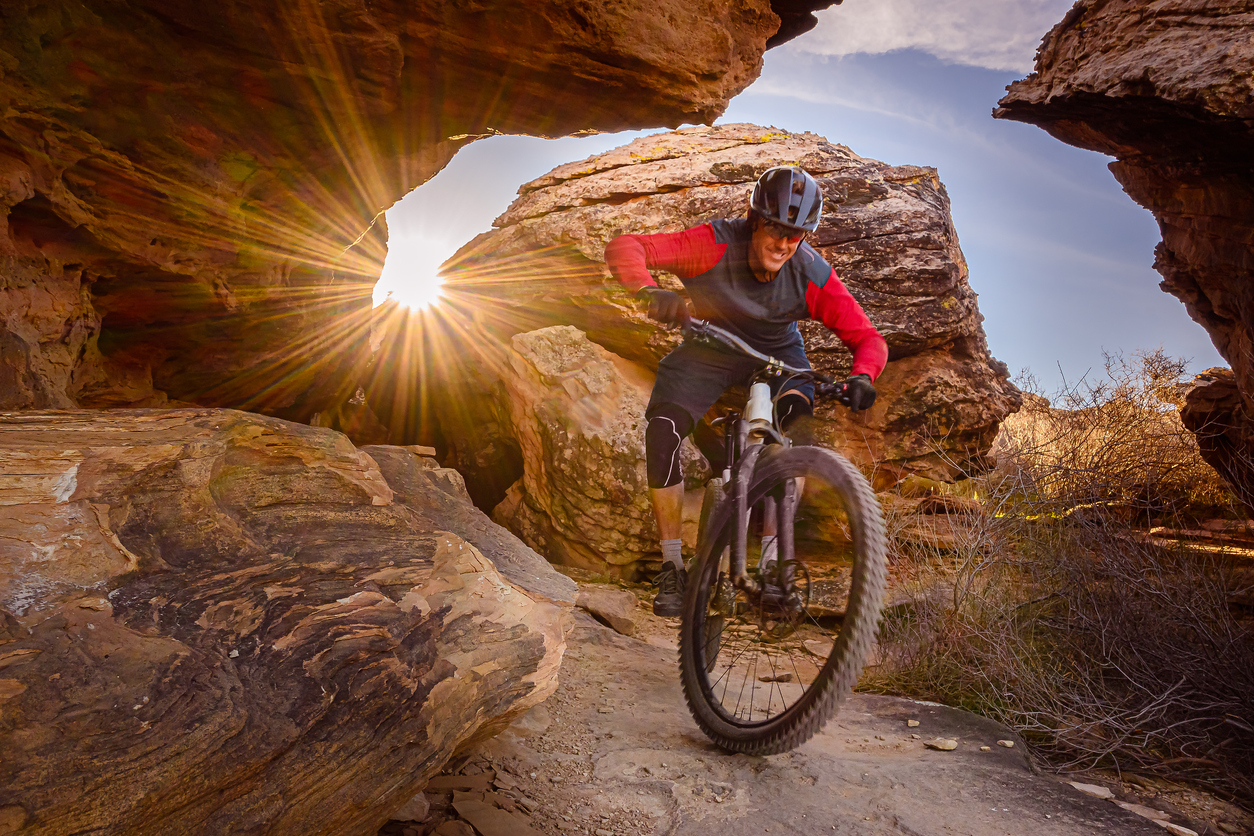 Mountain Biker Riding Through Boulders in The Southwest Desert
