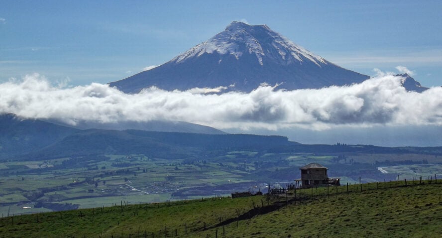 Cotopaxi is a mountain rising from the clouds, as seen from Corazon, a neighboring volcanic peak.