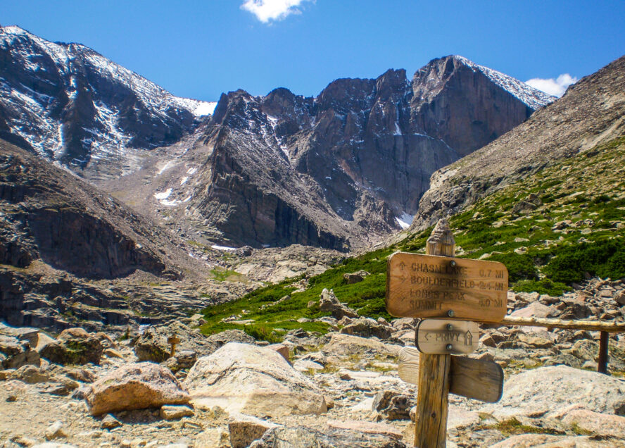 Longs Peak with trail map scene guiding your way many people die climbing this mountain. Estes Park , Colorado is near the Long Peak many many people attempt to climb this Peak and some do not survive. This shows the peak in Summer on a perfect day to climb. A colorado 14er