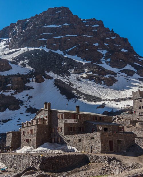 Toubkal national park in springtime with mount, cover by snow and ice, Refuge Toubkal, start point for hike to Jebel Toubkal, – highest peak of Atlas mountains and Morocco