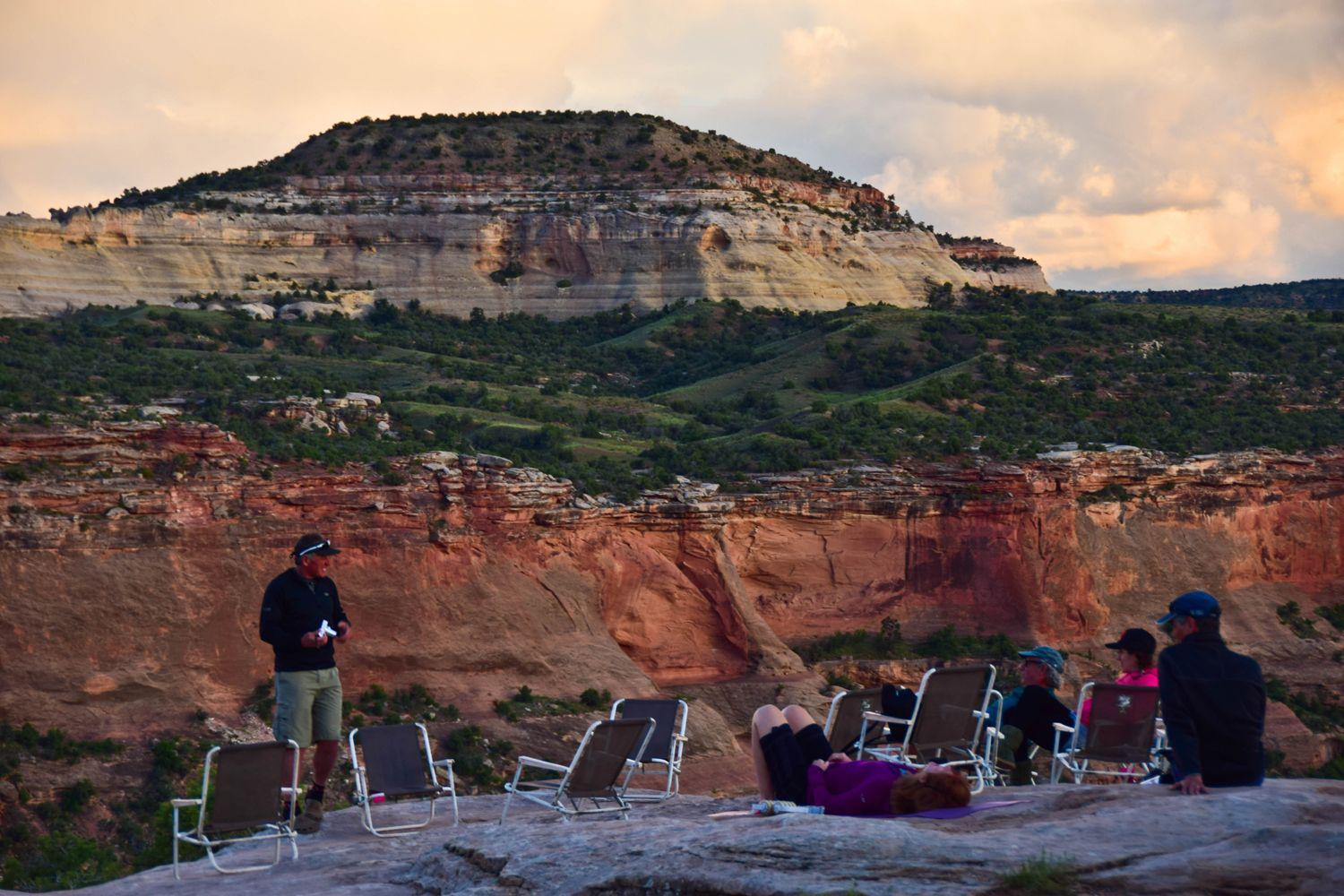 Mountain bikers sitting on their camping chairs and relaxing while enjoying views after riding the Kokopelli Trail.