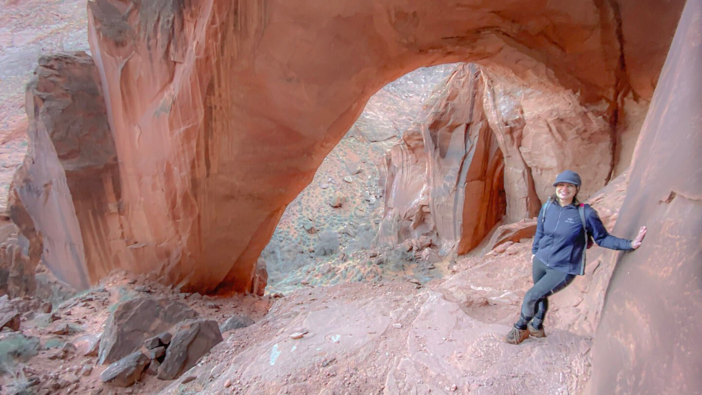 Woman hiking under the Wratch Arch
