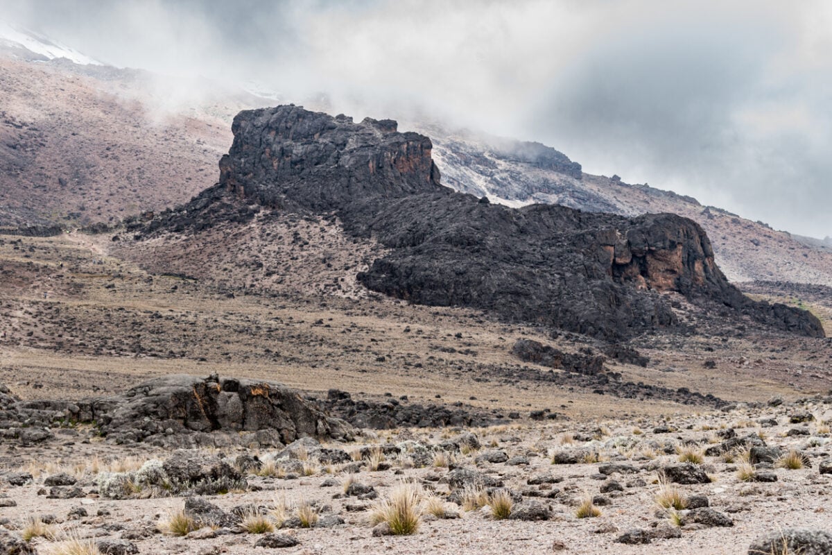 View of the Lava Tower in the alpine desert zone of the Machame route on Mount Kilimanjaro, under a light cloudy sky on a dry day on the Tanzanian volcanic mountain.