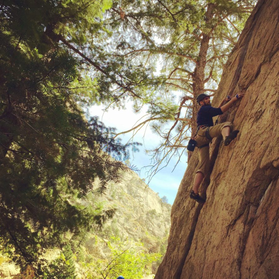 A climber climbing a cliff in Boulder Canyon