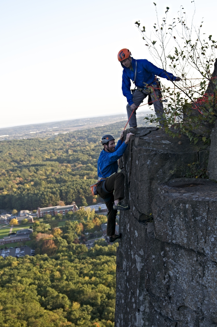 Two climbers helping each other out climbing Wiessner’s Rib