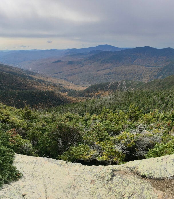 Man standing on the Mount Washington Summit