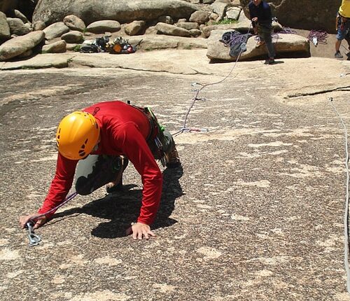 A group of people climbing La Pedriza.