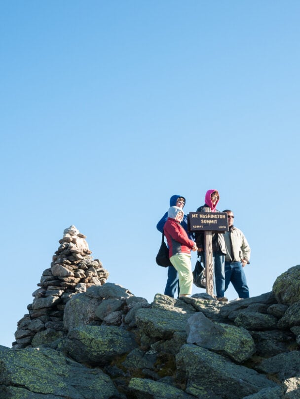Man standing on the Mount Washington Summit