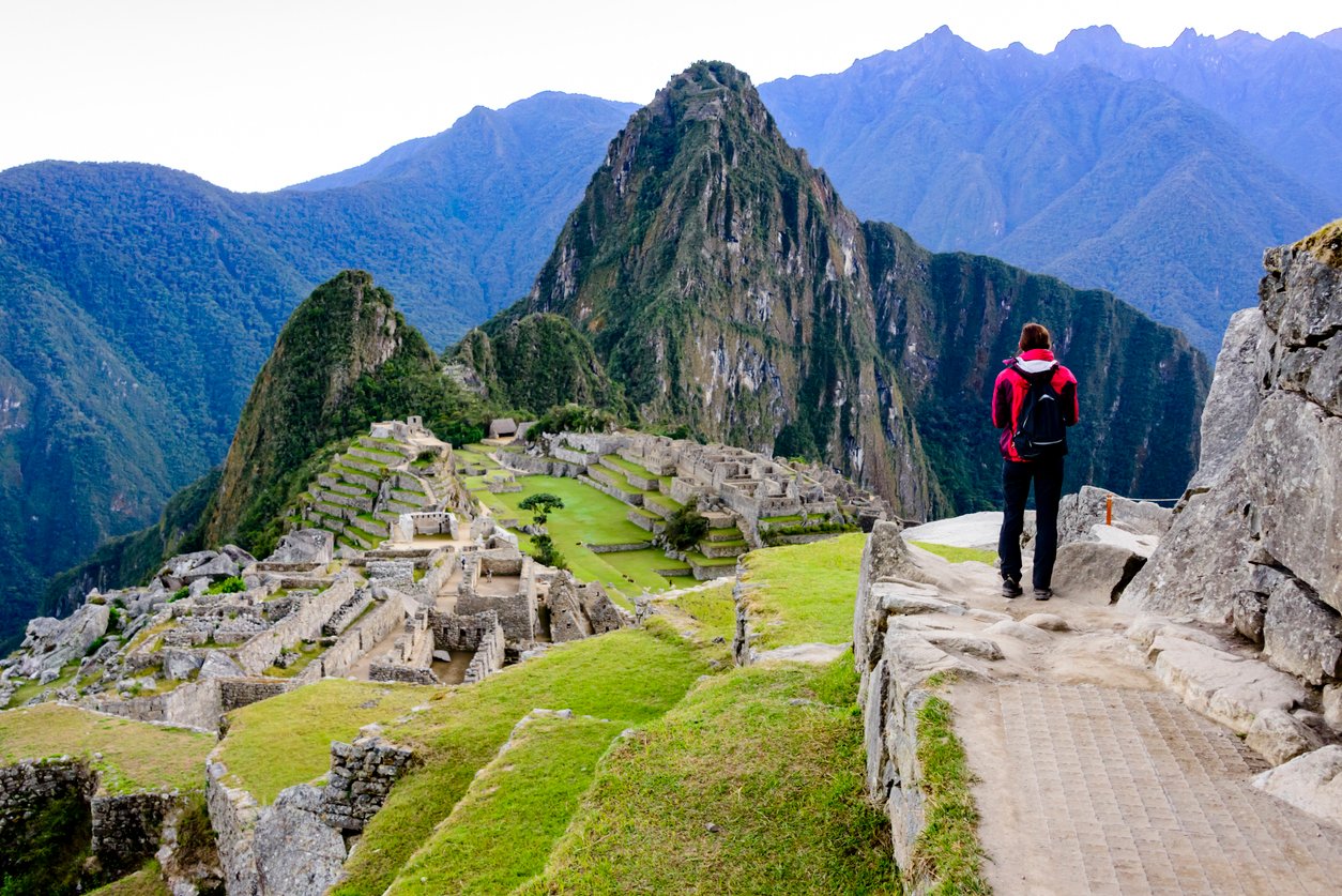 Woman standing in front of Machu Picchu