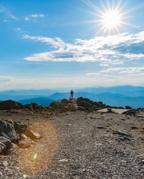 Man standing on the Mount Washington Summit