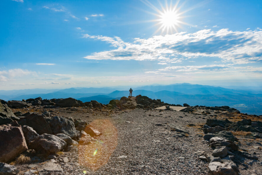 Man standing on the Mount Washington Summit