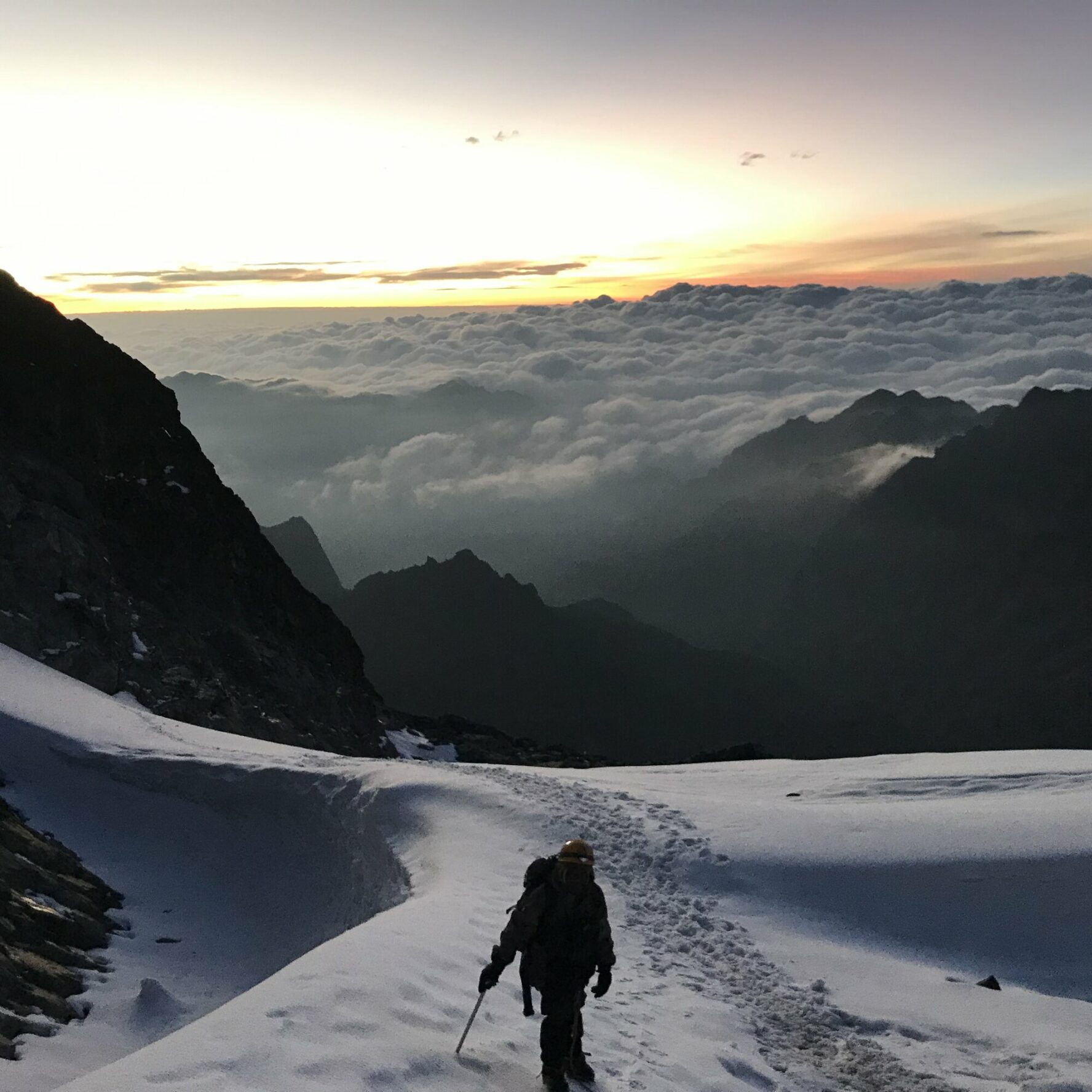 Man hiking a mountain on the Rwenzori trail
