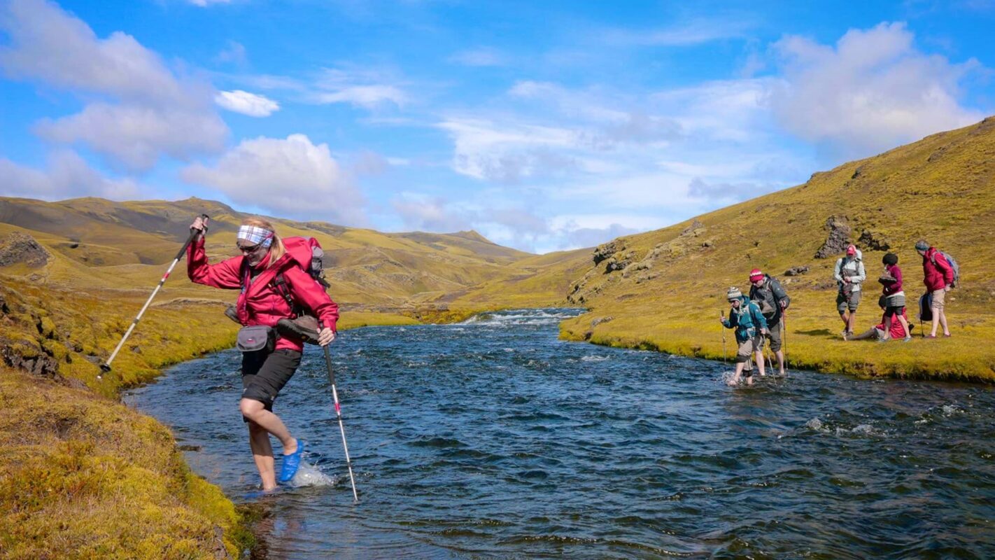 Hikers traveling along a riverside on Iceland