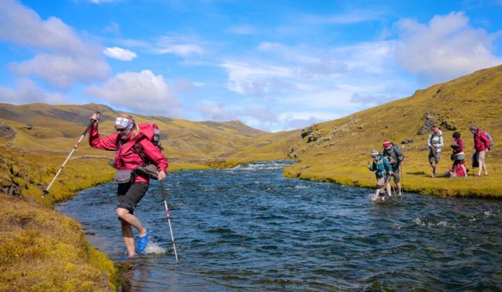 Hikers traveling along a riverside on Iceland