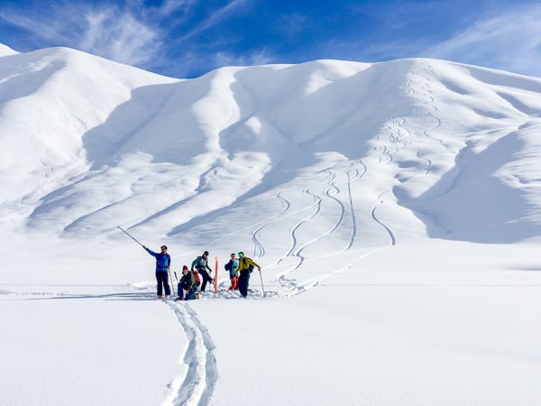 A skier pointing on a slope in Kyrgyzstan